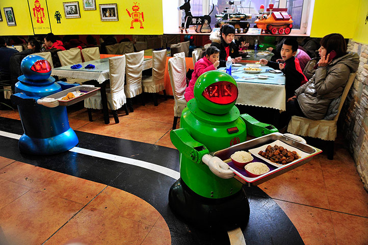 Robots deliver dishes to customers at a Robot Restaurant in Harbin